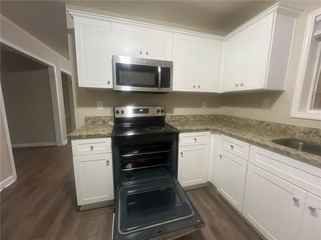 2785 Battle Forrest Drive Decatur, GA 30034 - Photo 5 of 16 a kitchen with granite countertop white cabinets and stainless steel appliances