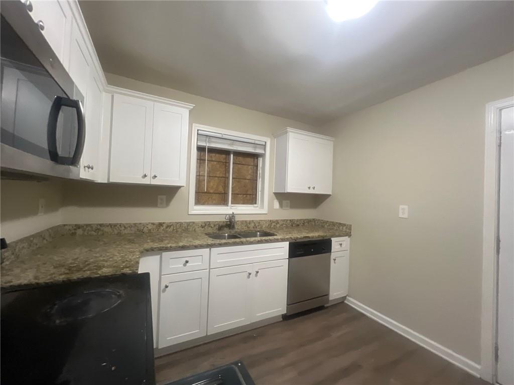 2785 Battle Forrest Drive Decatur, GA 30034 - Photo 6 of 16 a kitchen with granite countertop a sink and a stove top oven