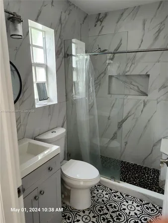 a bathroom with a toilet sink and shower
