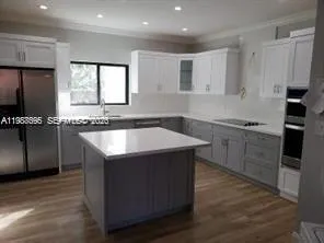 a kitchen that has a sink and a stove in it