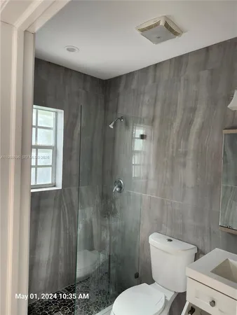 a white toilet sitting next to a bathroom sink