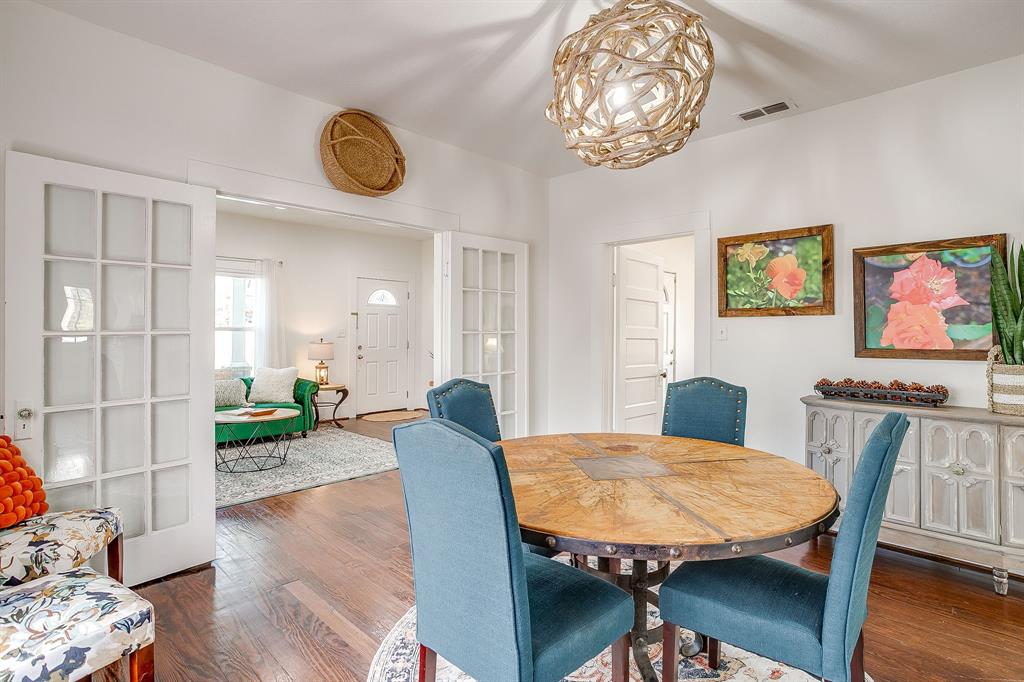 116 East Akard Street Weatherford, TX 76086 - Photo 11 of 32 a view of a dining room with furniture wooden floor and a chandelier
