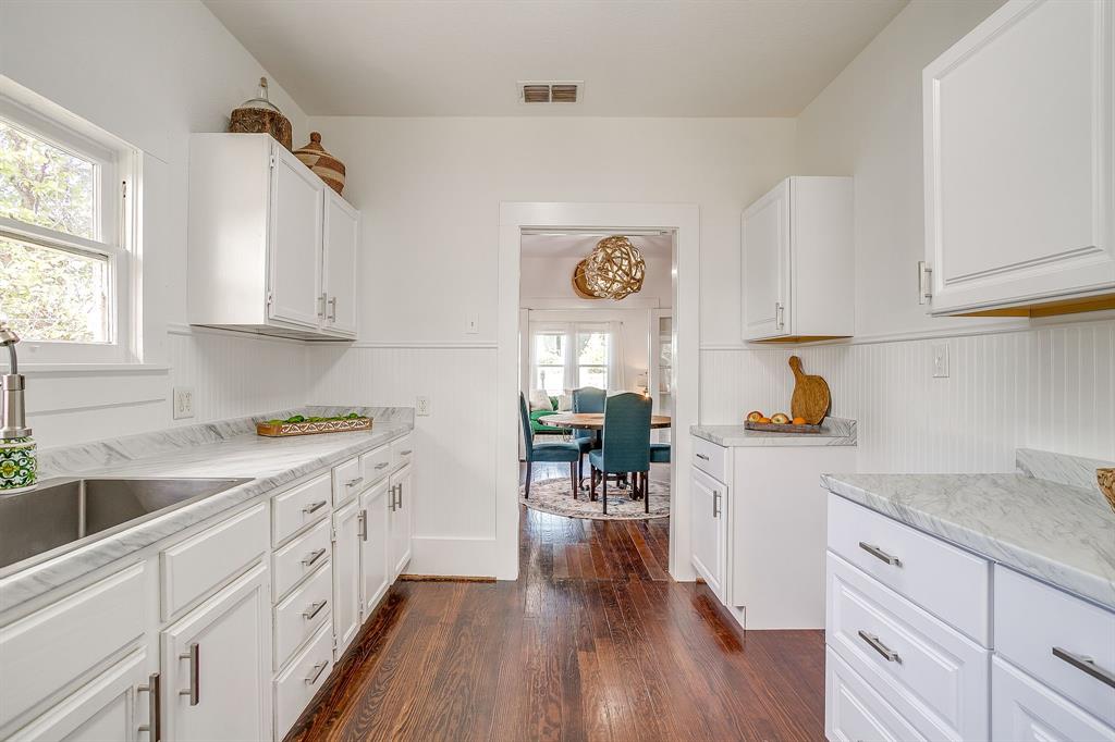 116 East Akard Street Weatherford, TX 76086 - Photo 21 of 32 a kitchen with a sink cabinets and wooden floor