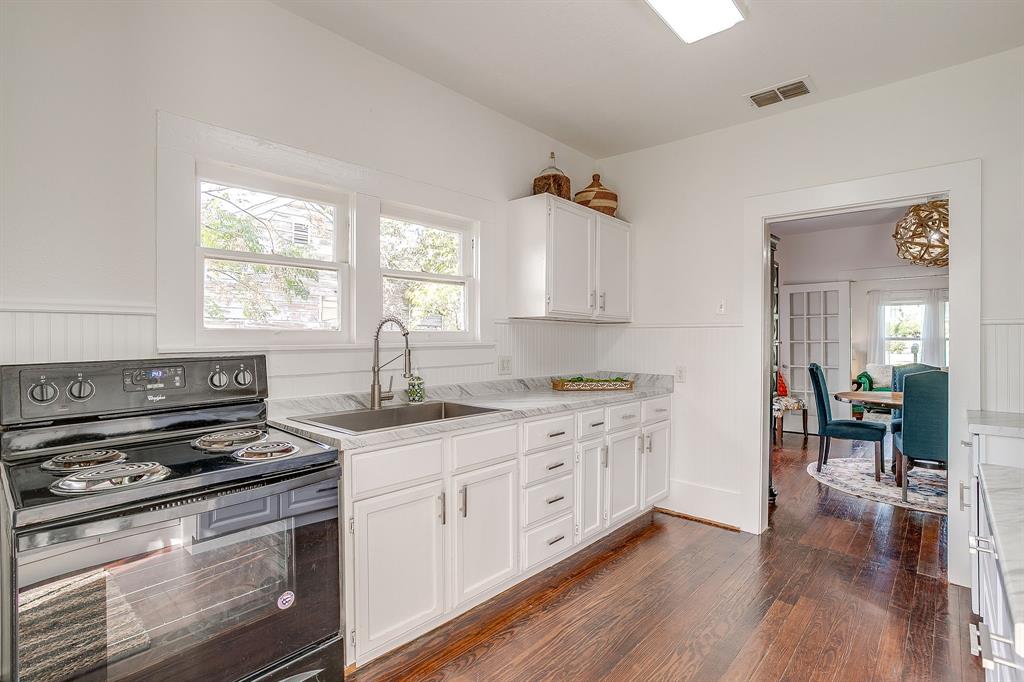 116 East Akard Street Weatherford, TX 76086 - Photo 22 of 32 a kitchen with stainless steel appliances a stove sink and cabinets
