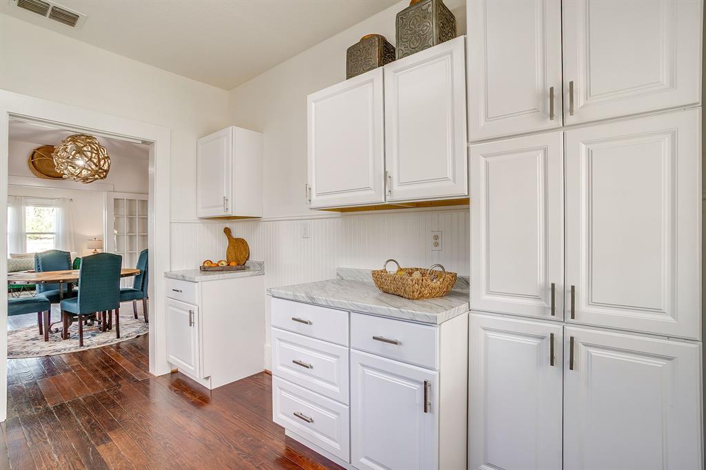 116 East Akard Street Weatherford, TX 76086 - Photo 23 of 32 a kitchen with a refrigerator and cabinets