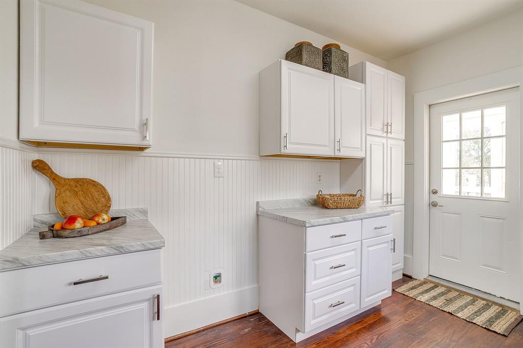 116 East Akard Street Weatherford, TX 76086 - Photo 24 of 32 a kitchen with cabinets appliances and a wooden floor