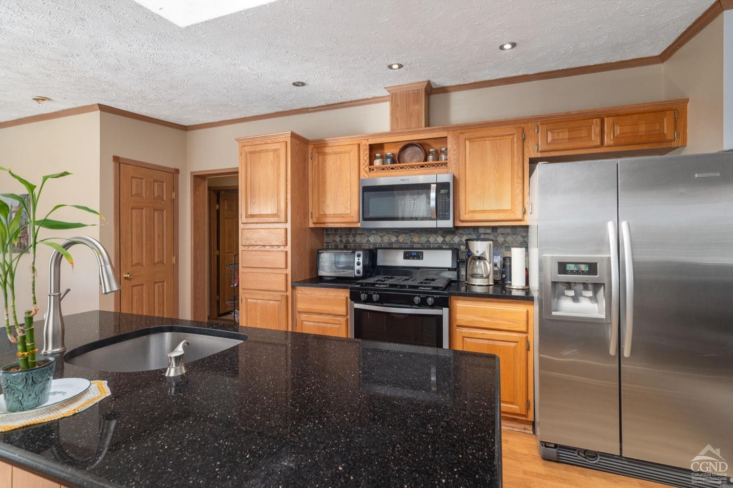188 Taibbi Road Gilboa, NY 12076 - Photo 17 of 54 a kitchen with stainless steel appliances granite countertop a refrigerator a stove and a sink with wooden floor