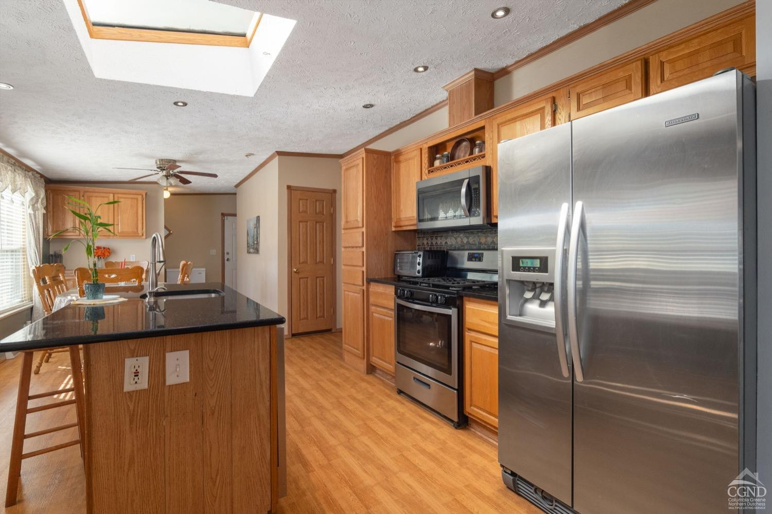 188 Taibbi Road Gilboa, NY 12076 - Photo 18 of 54 a kitchen with granite countertop stainless steel appliances and wooden cabinets