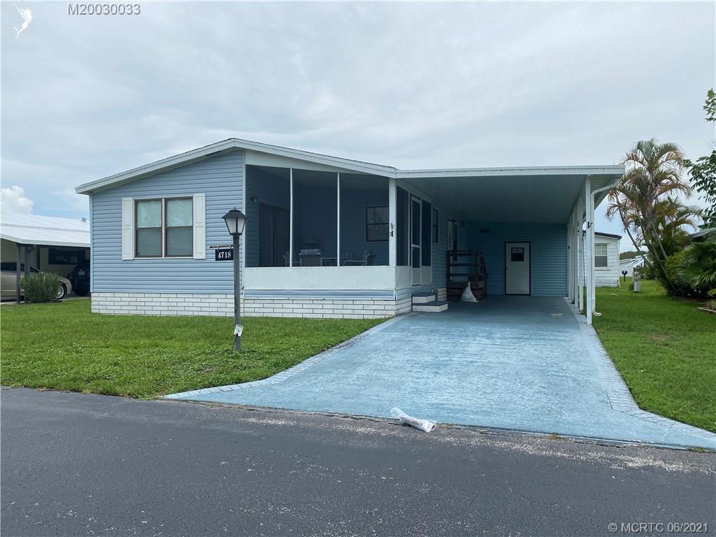 front view of a house with a yard and a garage