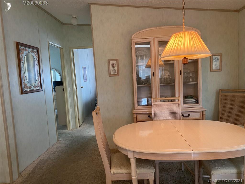4718 Southeast Balsawood Terrace Stuart, FL 34997 - Photo 11 of 25 a dining room with a table and chairs