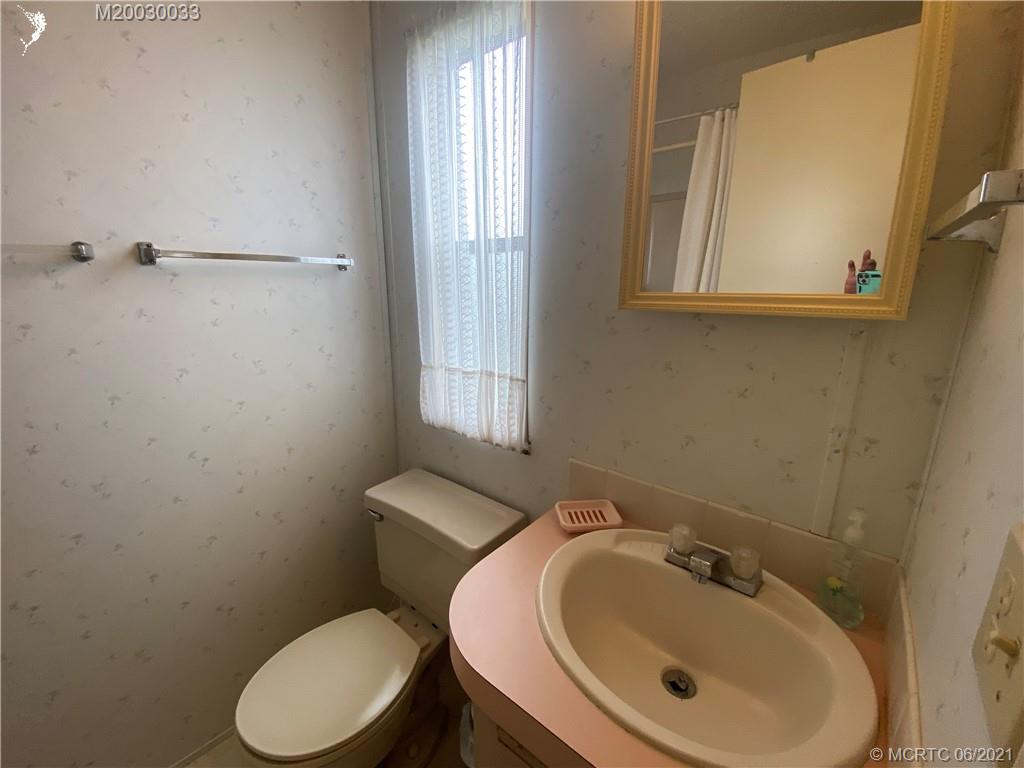4718 Southeast Balsawood Terrace Stuart, FL 34997 - Photo 17 of 25 a bathroom with a sink a toilet and mirror