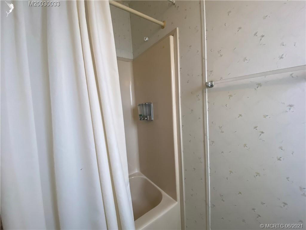 4718 Southeast Balsawood Terrace Stuart, FL 34997 - Photo 18 of 25 a bathroom with a tub