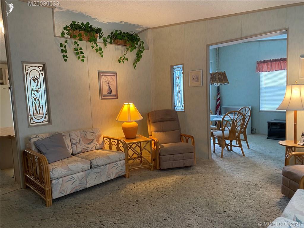4718 Southeast Balsawood Terrace Stuart, FL 34997 - Photo 2 of 25 a living room with furniture and a couch