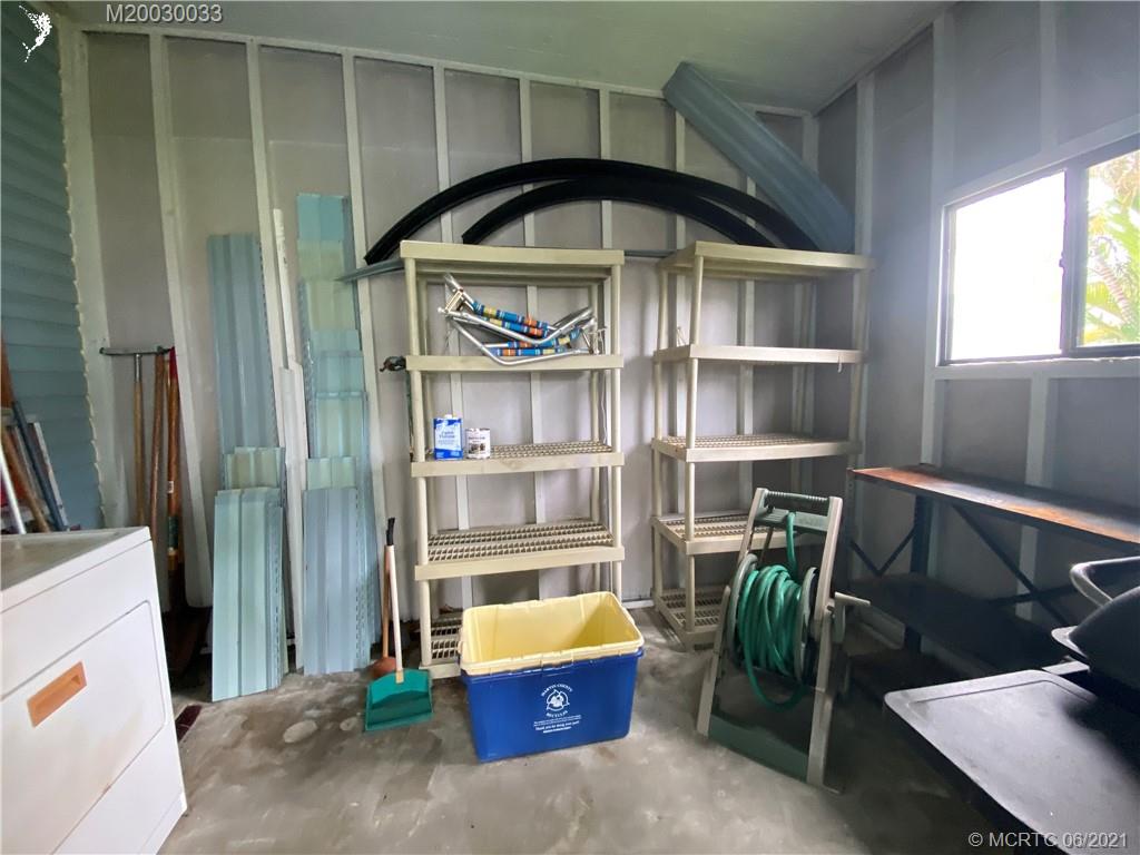 4718 Southeast Balsawood Terrace Stuart, FL 34997 - Photo 24 of 25 a front view of a house with outdoor space and shower