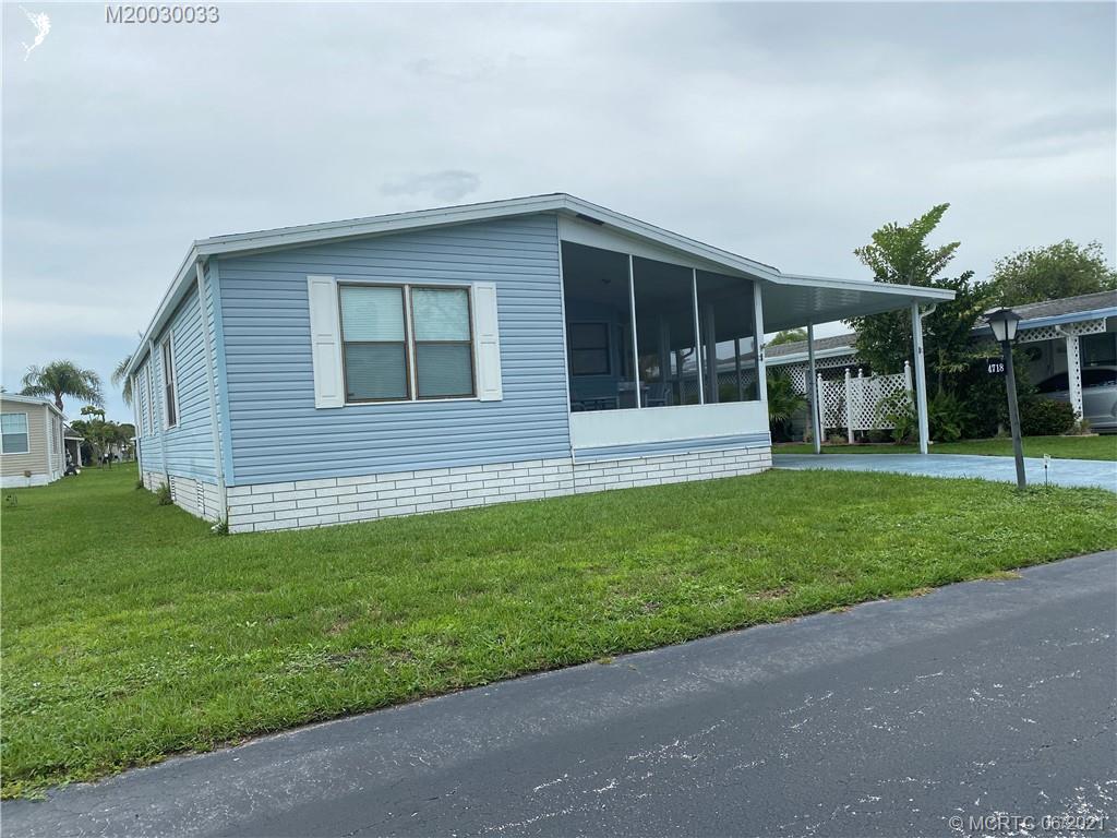 4718 Southeast Balsawood Terrace Stuart, FL 34997 - Photo 25 of 25 a house with garden in front of it