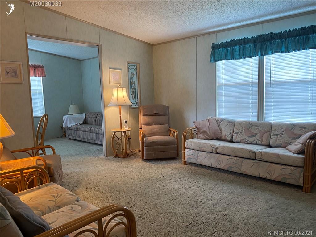 4718 Southeast Balsawood Terrace Stuart, FL 34997 - Photo 3 of 25 a living room with furniture