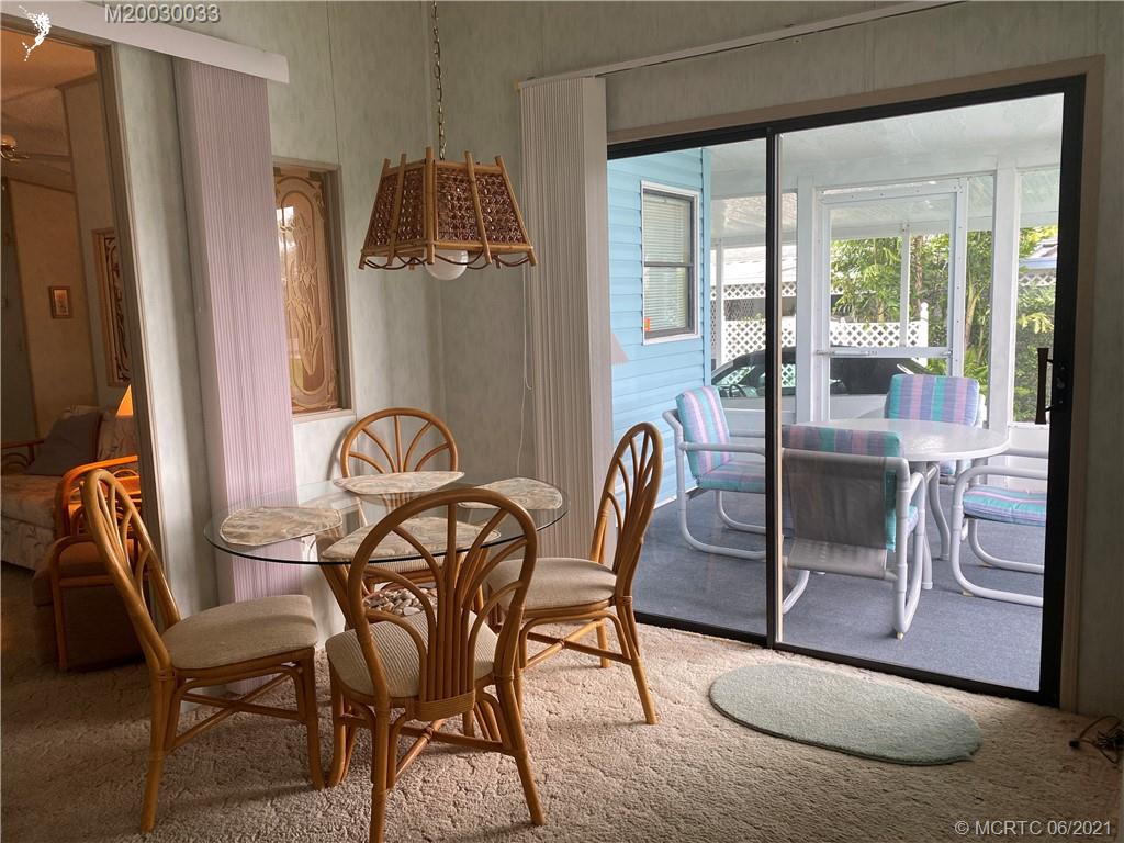 4718 Southeast Balsawood Terrace Stuart, FL 34997 - Photo 5 of 25 a view of a dining room with furniture window and outside view