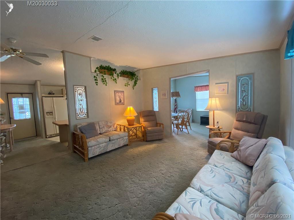 4718 Southeast Balsawood Terrace Stuart, FL 34997 - Photo 6 of 25 a living room with furniture and wooden floor