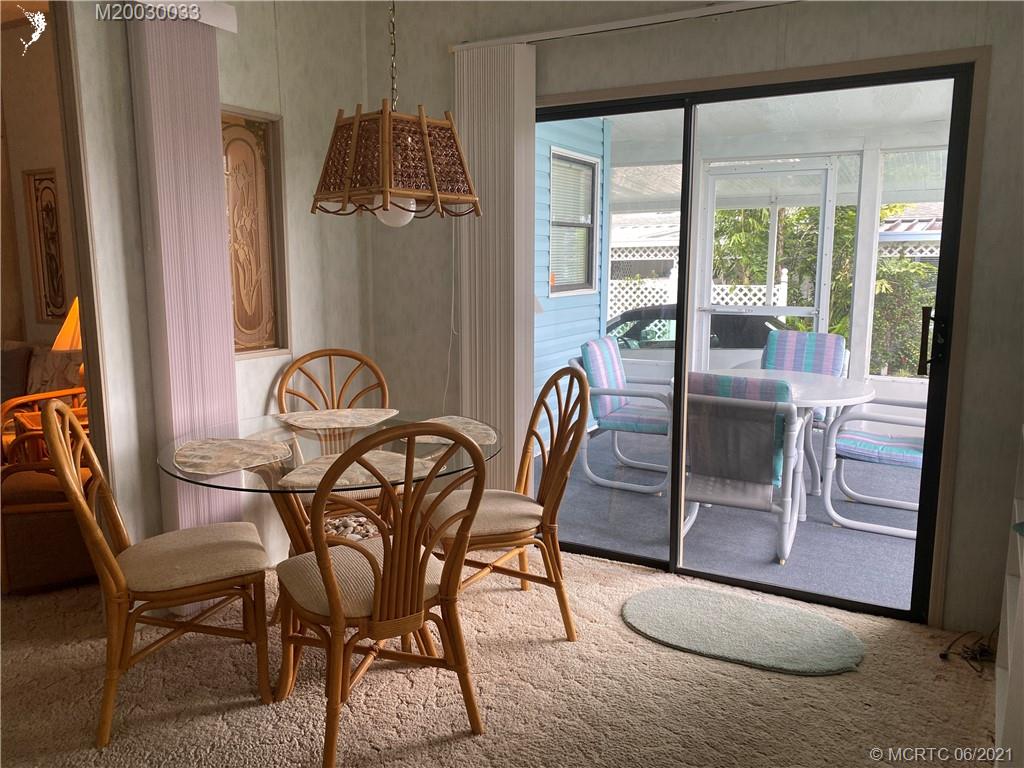4718 Southeast Balsawood Terrace Stuart, FL 34997 - Photo 7 of 25 a view of a dining room with furniture window and outside view