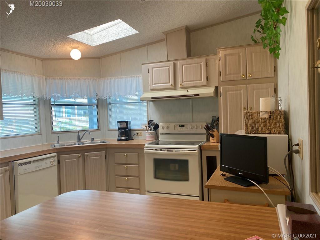 4718 Southeast Balsawood Terrace Stuart, FL 34997 - Photo 8 of 25 a kitchen with cabinets and chairs