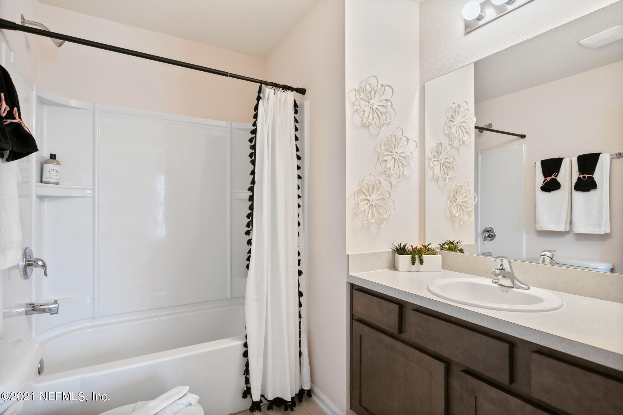 3972 Oak Mill Road Orange Park, FL 32065 - Photo 18 of 24 a bathroom with a bath tub sink mirror and shower