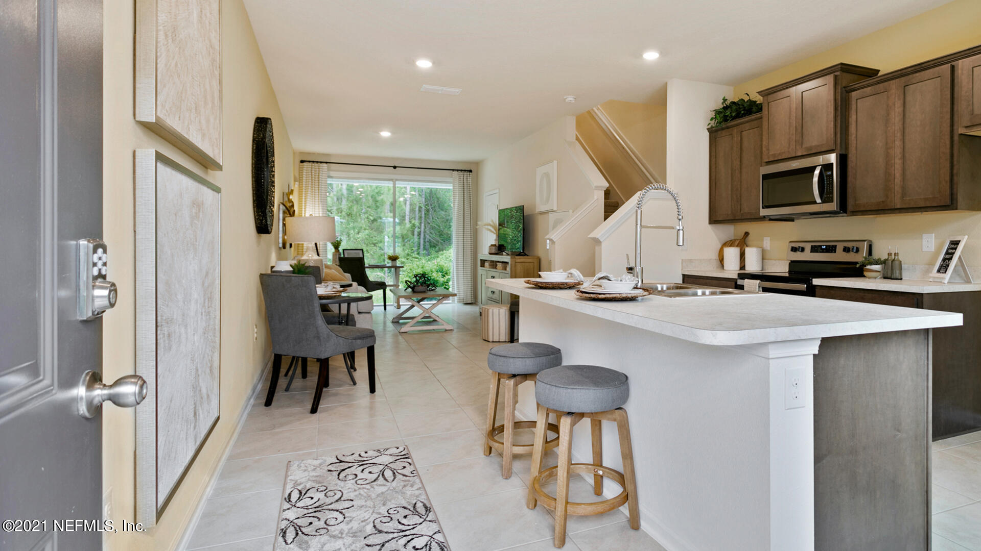 3972 Oak Mill Road Orange Park, FL 32065 - Photo 3 of 24 a kitchen with stainless steel appliances kitchen island granite countertop a refrigerator and a sink