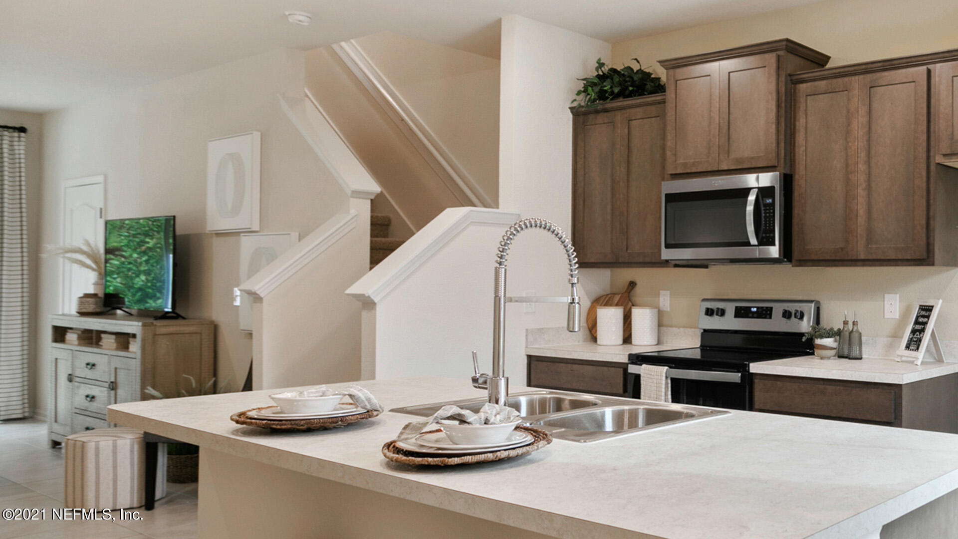 3972 Oak Mill Road Orange Park, FL 32065 - Photo 4 of 24 a kitchen with stainless steel appliances kitchen island granite countertop a sink dishwasher and microwave with wooden floor