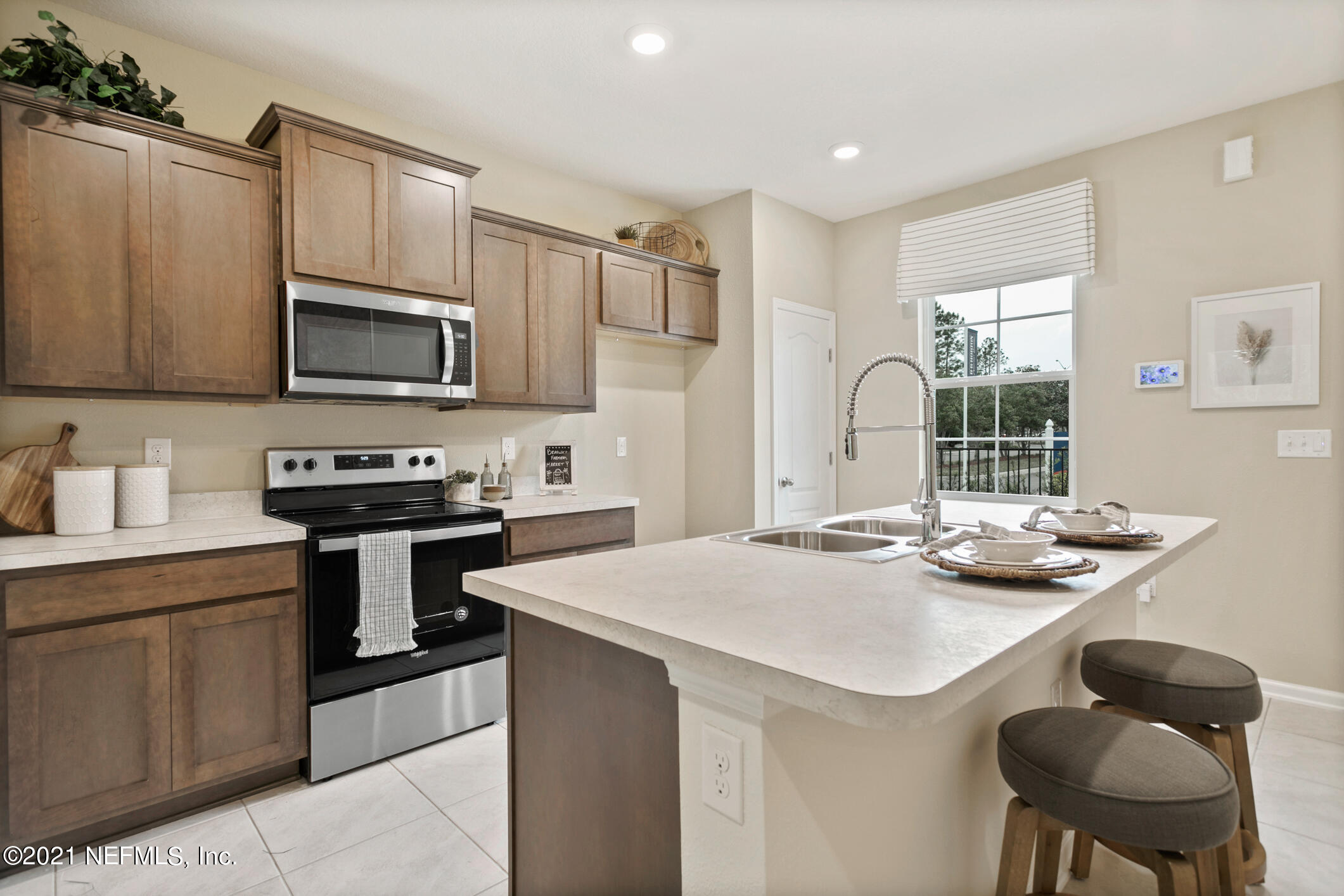 3972 Oak Mill Road Orange Park, FL 32065 - Photo 5 of 24 a kitchen with kitchen island a stove a sink and a refrigerator