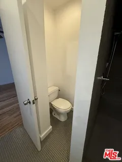 a white toilet sitting next to a sink