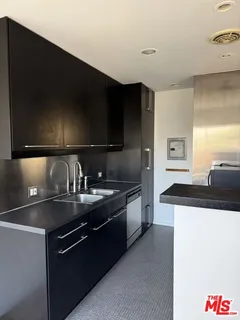 a kitchen with stainless steel appliances granite countertop a sink and a stove