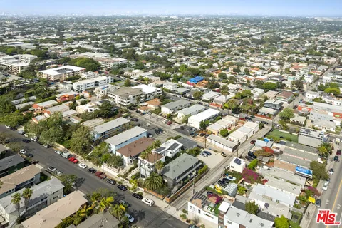 an aerial view of residential building with parking