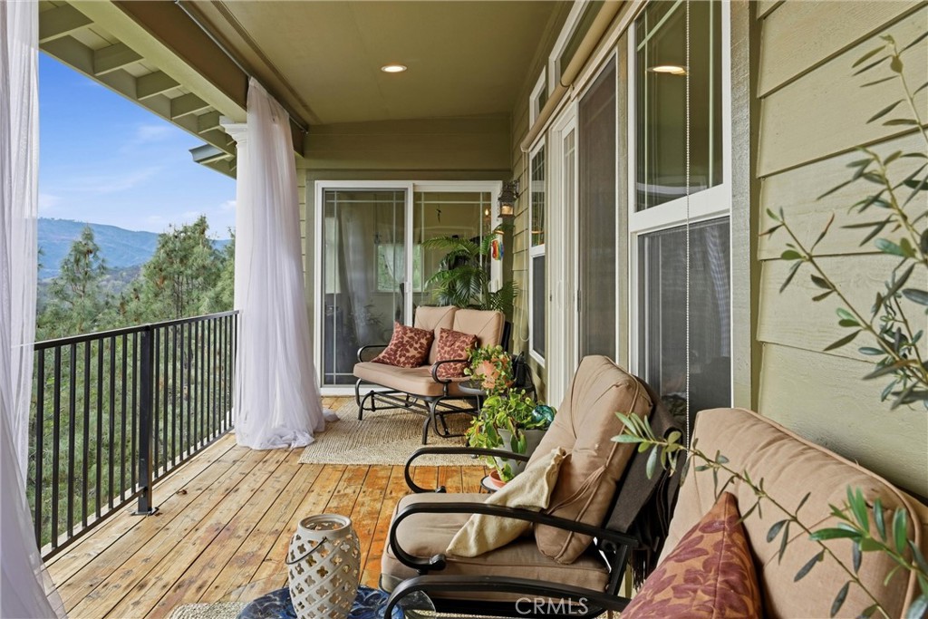 18750 Fernwood Road Hidden Valley Lake, CA 95467 - Photo 17 of 53 a balcony with wooden floor table and chairs