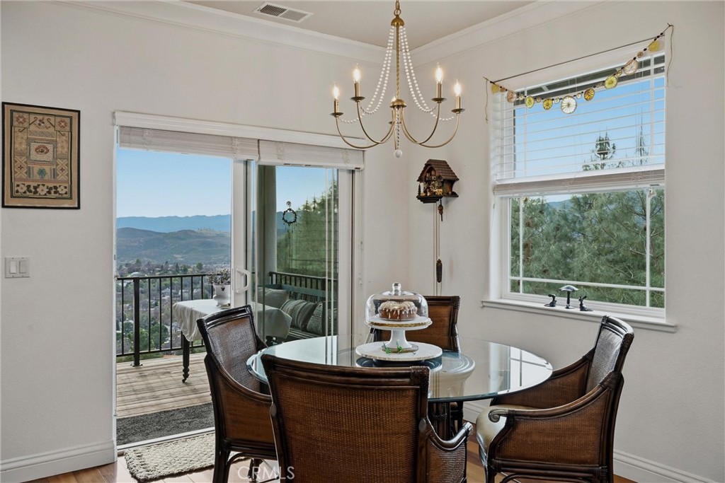 18750 Fernwood Road Hidden Valley Lake, CA 95467 - Photo 25 of 53 a view of a dining room with furniture wooden floor and chandelier