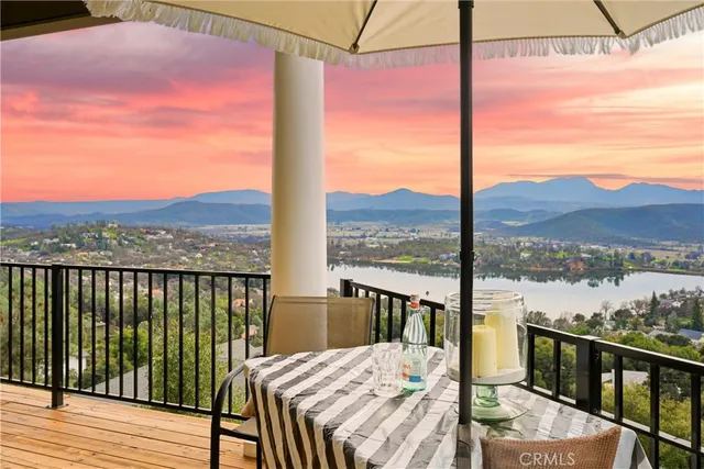 a spacious bedroom with a bed and chair