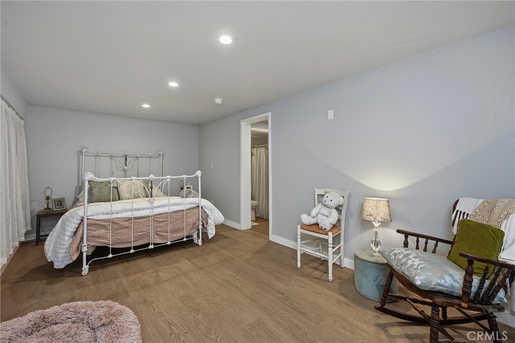 18750 Fernwood Road Hidden Valley Lake, CA 95467 - Photo 50 of 53 a spacious bedroom with a bed and chair