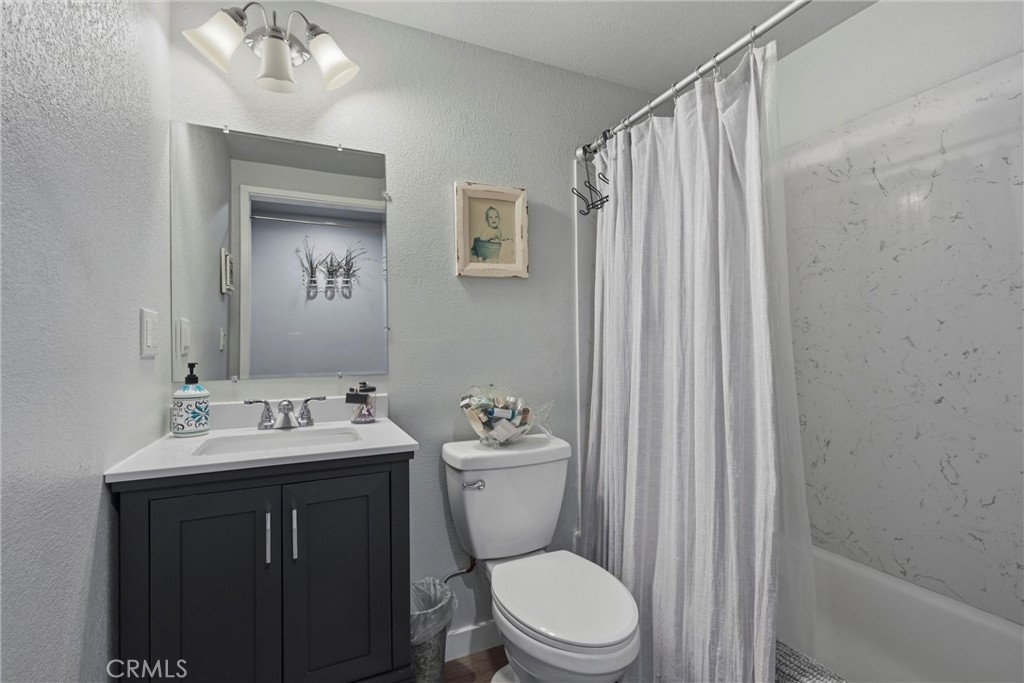 18750 Fernwood Road Hidden Valley Lake, CA 95467 - Photo 51 of 53 a bathroom with a toilet a sink and a mirror