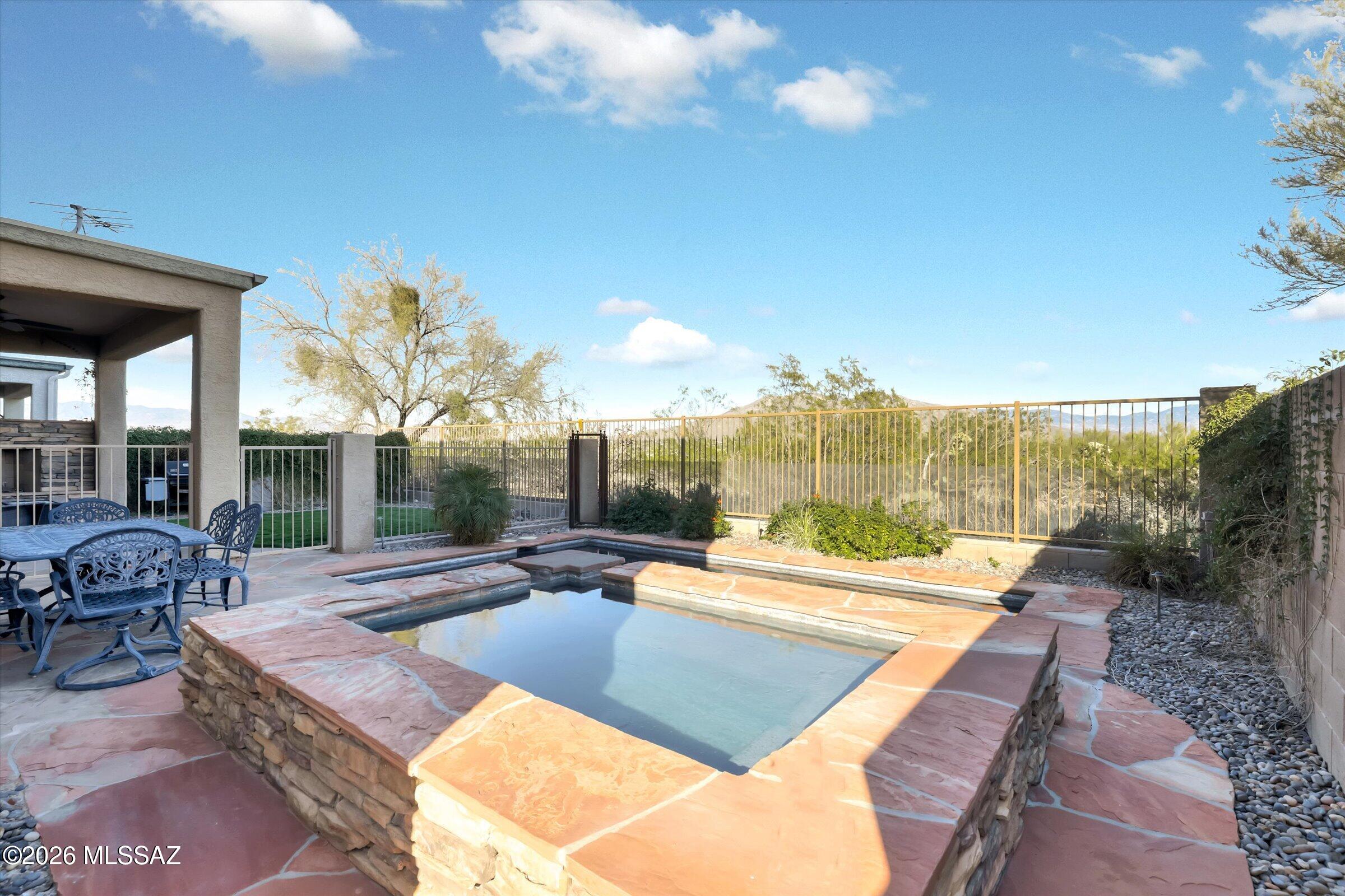 6095 South Jakemp Trail Tucson, AZ 85747 - Photo 3 of 52 a building outdoor space with patio furniture and potted plants