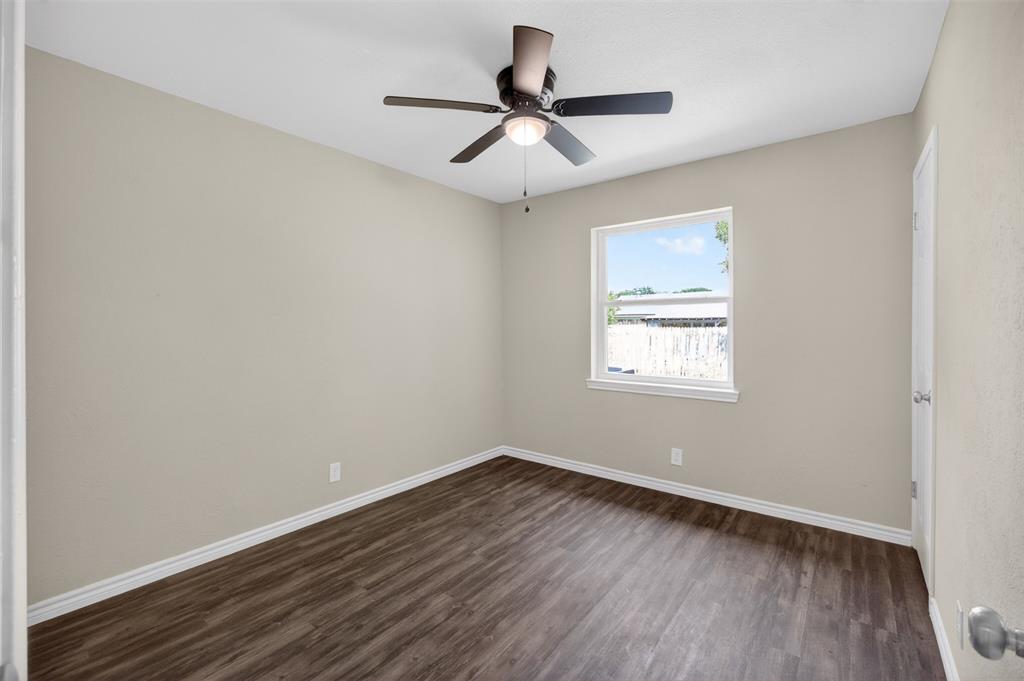 7528 Meadowlark Lane North Watauga, TX 76148 - Photo 15 of 31 wooden floor in an empty room with a window