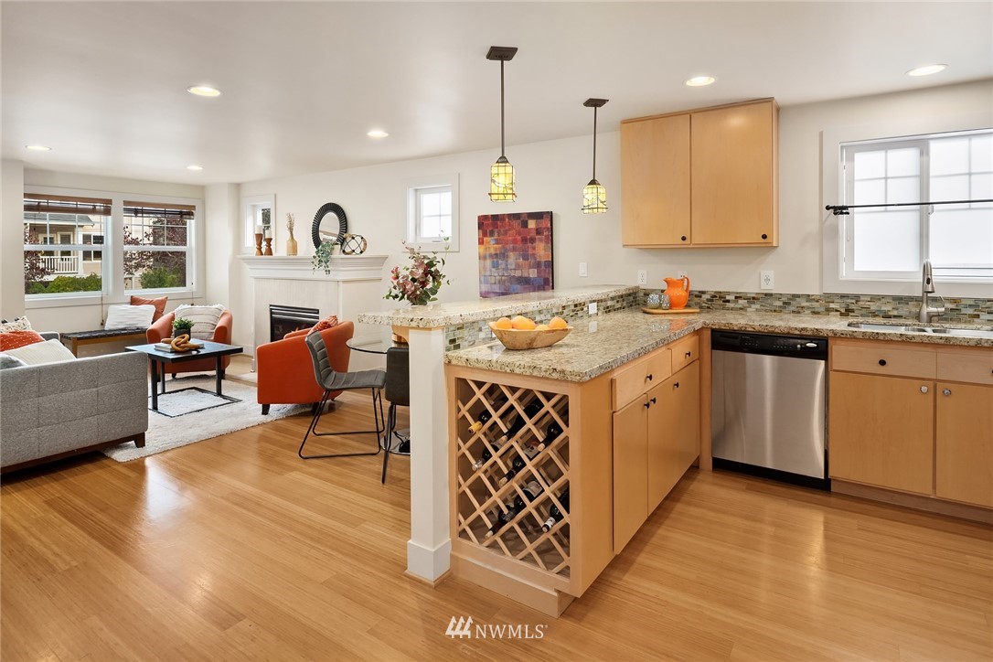 723 North 95th Street, Unit B Seattle, WA 98103 - Photo 2 of 24 a kitchen that has a lot of cabinets a sink and a wooden floor