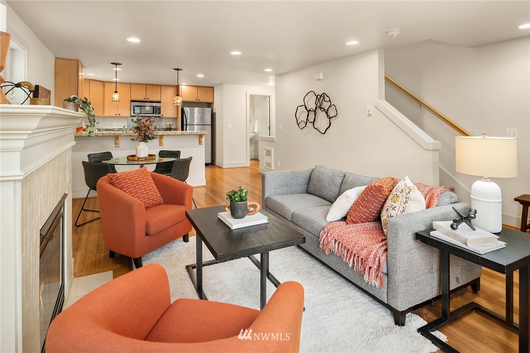 723 North 95th Street, Unit B Seattle, WA 98103 - Photo 12 of 24 a living room with furniture kitchen view and a chandelier