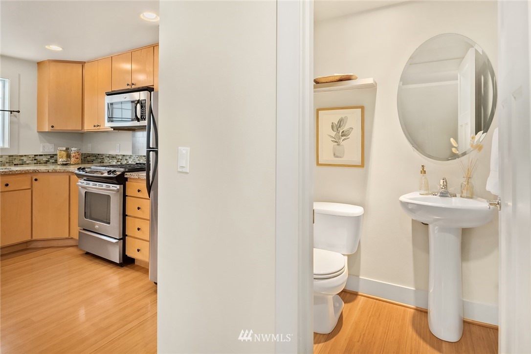 723 North 95th Street, Unit B Seattle, WA 98103 - Photo 13 of 24 a bathroom with a toilet sink and mirror