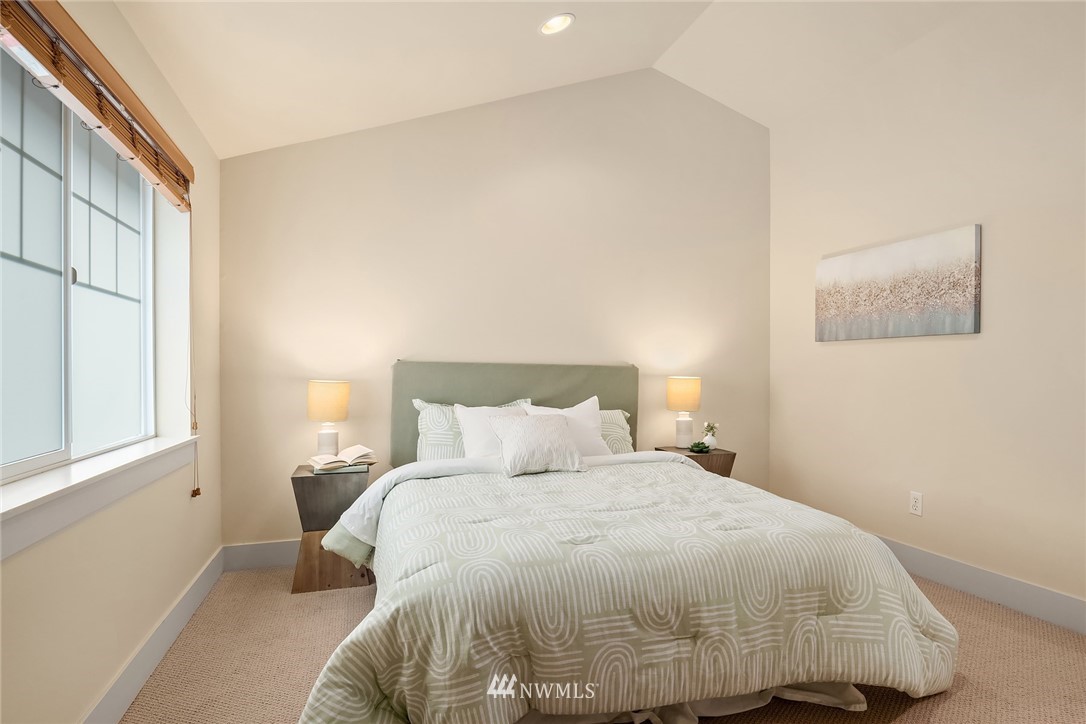 723 North 95th Street, Unit B Seattle, WA 98103 - Photo 16 of 24 a bedroom with a bed and wooden floor