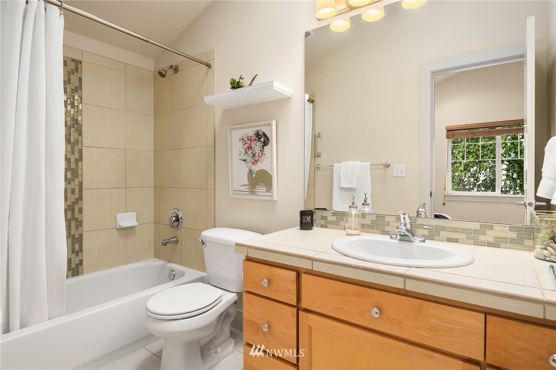 723 North 95th Street, Unit B Seattle, WA 98103 - Photo 19 of 24 a bathroom with a sink toilet and shower