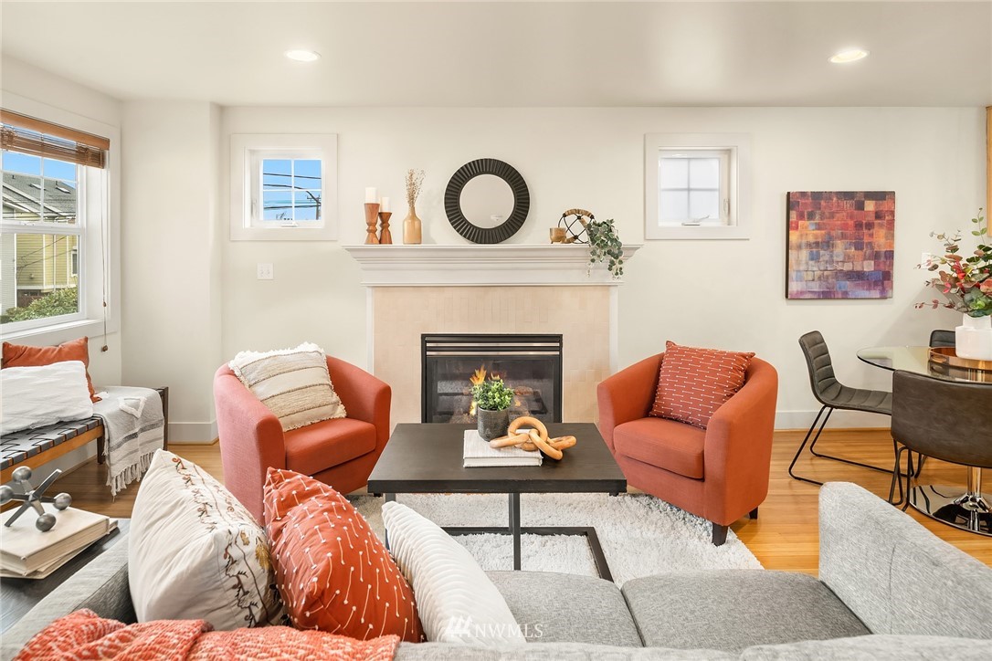 723 North 95th Street, Unit B Seattle, WA 98103 - Photo 10 of 24 a living room with furniture a fireplace and a wall painting