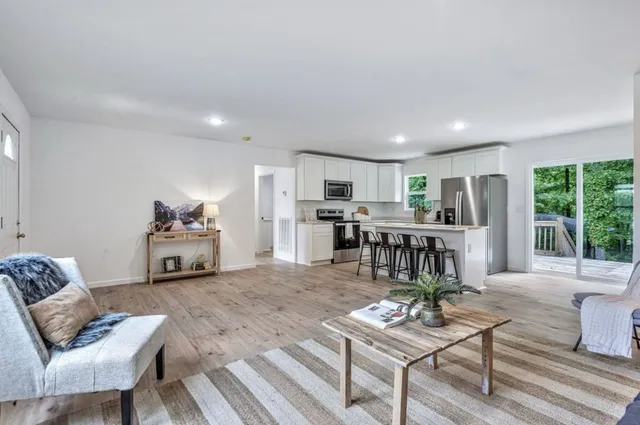 a kitchen with kitchen island a stove a sink and a refrigerator