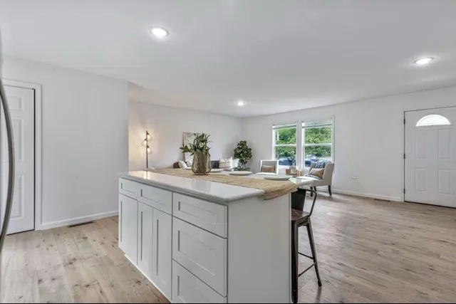 a bedroom with a bed and a table in it with window
