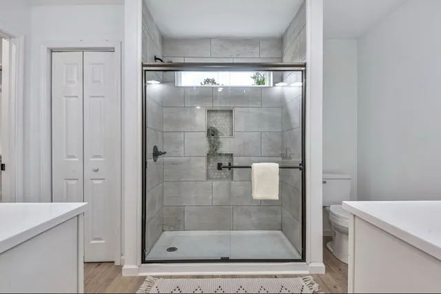 a bathroom with a shower and a sink