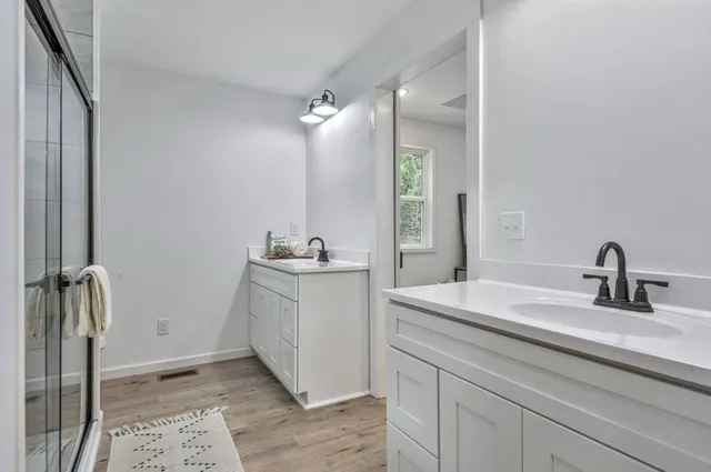 a bathroom with a double vanity sink and mirror