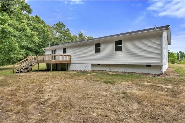 a view of a field with trees in the background