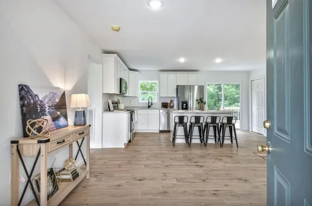 a living room with furniture wooden floor and a window